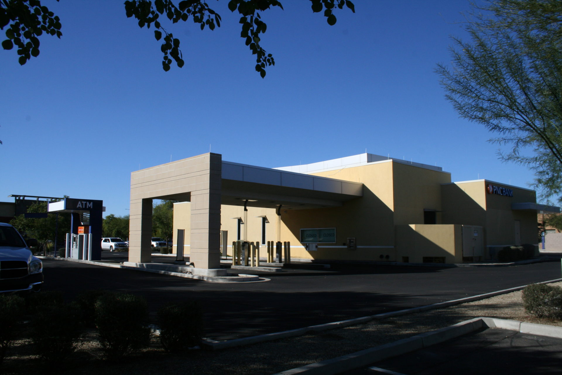 A building with a large entrance and a parking lot.