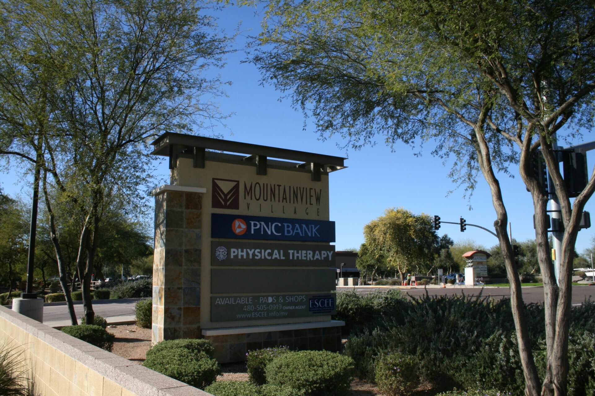 A sign for the physical therapy center in front of some trees.